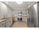 Modern kitchen features gray cabinets, stainless steel appliances, and wood countertops at 1411 Rosewood St, Durham, NC 27701