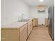 Kitchen with wood cabinets, stainless steel refrigerator, and ample counter space at 1411 Rosewood St, Durham, NC 27701