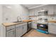 Updated kitchen showcasing wood countertops, grey cabinets, and stainless steel appliances at 1411 Rosewood St, Durham, NC 27701