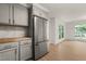 Kitchen showcases stainless steel refrigerator, wood countertops, and view to living space at 1411 Rosewood St, Durham, NC 27701