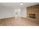 Living room featuring a stone fireplace and light hardwood floors at 1411 Rosewood St, Durham, NC 27701