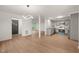 Open concept living area with modern lighting and view of updated kitchen at 1411 Rosewood St, Durham, NC 27701