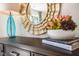 Dresser features stylish decor with a decorative mirror, floral arrangement, and design books at 149 Ethel Ln, Angier, NC 27501