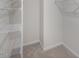 Walk-in closet with wire shelving and neutral carpet at 149 Ethel Ln, Angier, NC 27501
