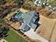 Aerial view featuring the rear of a gray home, complete with a pool and a well-kept lawn at 1520 Grand Willow Way, Raleigh, NC 27614