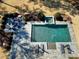 Aerial view of the pool, spa, outdoor living area, and landscaped yard at 1520 Grand Willow Way, Raleigh, NC 27614