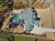 Overhead view of the gray home showcasing a pristine pool, stone patio and manicured landscaping at 1520 Grand Willow Way, Raleigh, NC 27614