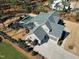 Stunning aerial view of a gray two-story home with a pool and a well manicured lawn at 1520 Grand Willow Way, Raleigh, NC 27614