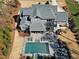 Back aerial view showcasing a large pool, patio, covered veranda, and a well-maintained lawn at 1520 Grand Willow Way, Raleigh, NC 27614