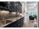 A sophisticated bar area with custom cabinetry, granite countertops, and a convenient wine cooler at 1520 Grand Willow Way, Raleigh, NC 27614