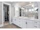 Elegant bathroom vanity with marble countertops, double sinks, and access to walk-in closet at 1520 Grand Willow Way, Raleigh, NC 27614