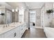 Spacious bathroom with double vanity, marble countertops, and access to a large walk-in closet at 1520 Grand Willow Way, Raleigh, NC 27614