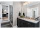 Modern bathroom featuring a granite countertop vanity and a tiled walk-in shower at 1520 Grand Willow Way, Raleigh, NC 27614