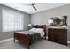 Comfortable bedroom with a ceiling fan, a wooden bed frame, and gray walls at 1520 Grand Willow Way, Raleigh, NC 27614