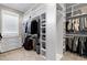 Large walk-in closet featuring custom shelving, drawers, and ample storage space at 1520 Grand Willow Way, Raleigh, NC 27614