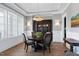 Formal dining room with hardwood floors, wainscoting, modern chandelier and built-in china cabinet at 1520 Grand Willow Way, Raleigh, NC 27614