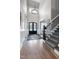 Grand foyer boasts hardwood floors, a statement chandelier, and staircase leading to the upper level at 1520 Grand Willow Way, Raleigh, NC 27614