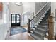 Elegant entryway featuring hardwood floors, a staircase, and a statement chandelier at 1520 Grand Willow Way, Raleigh, NC 27614