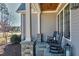 Inviting front porch with stone pillars, seating, and a view of the neighborhood at 1520 Grand Willow Way, Raleigh, NC 27614