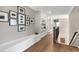 Hallway with hardwood floors, white trim, and built-in shelving, great for displaying decor at 1520 Grand Willow Way, Raleigh, NC 27614