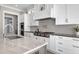 Close-up of kitchen showing stainless appliances, custom cabinetry, and a kitchen island with seating at 1520 Grand Willow Way, Raleigh, NC 27614