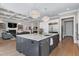 Open-concept kitchen with a large island, stainless steel appliances, and seamless flow to the living area at 1520 Grand Willow Way, Raleigh, NC 27614