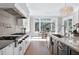 Gourmet kitchen with stainless steel appliances, an island with seating, and an adjacent breakfast nook at 1520 Grand Willow Way, Raleigh, NC 27614