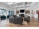 Elegant living room with fireplace, built-in shelves, hardwood floors, and sliding glass doors to the patio at 1520 Grand Willow Way, Raleigh, NC 27614