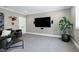 Comfortable living room area includes an oversized TV, stylish decor, and plush sectional seating at 1520 Grand Willow Way, Raleigh, NC 27614