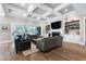 Spacious living area with fireplace, custom built-ins, and sliding glass doors that connect to the backyard at 1520 Grand Willow Way, Raleigh, NC 27614