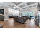 Open-concept living room with hardwood floors, coffered ceilings, and seamless access to the outdoors at 1520 Grand Willow Way, Raleigh, NC 27614