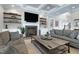 Relaxing living room with a fireplace, wood floors, coffered ceiling, and a large coffee table at 1520 Grand Willow Way, Raleigh, NC 27614