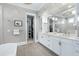 Luxury bathroom with a soaking tub, double vanity, and access to a walk-in closet at 1520 Grand Willow Way, Raleigh, NC 27614