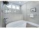 Modern bathroom featuring a freestanding tub, elegant fixtures, and a rain shower head at 1520 Grand Willow Way, Raleigh, NC 27614