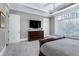 Spacious main bedroom boasts a large window, dresser, TV, and comfortable carpeting at 1520 Grand Willow Way, Raleigh, NC 27614