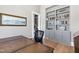 Well-lit home office space with custom shelving and a classic desk, perfect for productivity at 1520 Grand Willow Way, Raleigh, NC 27614