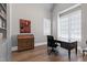Bright office space with built-in shelving, a large desk, and natural light from large windows at 1520 Grand Willow Way, Raleigh, NC 27614