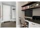 Home office area featuring built-in shelving, a desk, and a mudroom entrance at 1520 Grand Willow Way, Raleigh, NC 27614