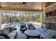 Relaxing outdoor area with stone fireplace, comfortable seating, ceiling fan, and view of the pool at 1520 Grand Willow Way, Raleigh, NC 27614
