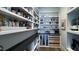A well-organized pantry with floor-to-ceiling shelves, countertop space, and wood flooring at 1520 Grand Willow Way, Raleigh, NC 27614