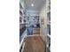A well-organized pantry with floor-to-ceiling shelves, countertop space, and wood flooring at 1520 Grand Willow Way, Raleigh, NC 27614