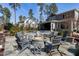 Outdoor fire pit area with Adirondack chairs on a stone patio, surrounded by mature trees at 1520 Grand Willow Way, Raleigh, NC 27614