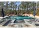 Inviting in-ground pool with a stone surround, integrated spa, and lounge chairs on the sun deck at 1520 Grand Willow Way, Raleigh, NC 27614