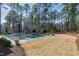 Backyard oasis with a rectangular pool surrounded by trees and lounge chairs at 1520 Grand Willow Way, Raleigh, NC 27614