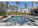 Beautiful in-ground pool with a stone surround, integrated spa and sun deck surrounded by mature trees at 1520 Grand Willow Way, Raleigh, NC 27614