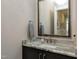 Stylish powder room with granite countertop and decorative mirror at 1520 Grand Willow Way, Raleigh, NC 27614