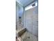 Walk-in shower featuring gray tiles, a glass door, and a built-in seat at 1520 Grand Willow Way, Raleigh, NC 27614