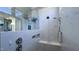 Contemporary shower with a tiled bench, rainfall shower head, and marble walls at 1520 Grand Willow Way, Raleigh, NC 27614