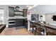 Wet bar features dark wood cabinetry, granite countertops, stainless steel appliances, and seating at 1520 Grand Willow Way, Raleigh, NC 27614