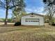 The home has a detached one-car garage with paneled doors and surrounding trees at 15616 Nc 96 Hwy, Zebulon, NC 27597